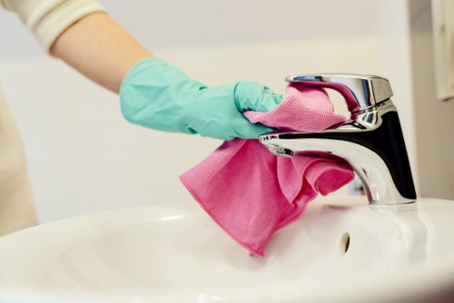 Cleaners removing dust after renovation in a Wimbledon home