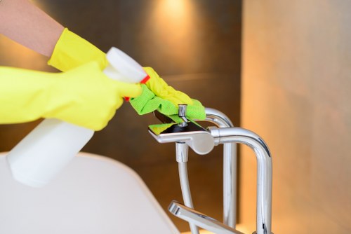Professional cleaner preparing a spotless Wimbledon home interior