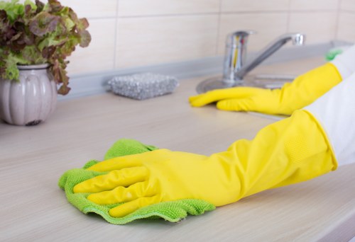 Cleaner treating a carpet stain in a Wimbledon room
