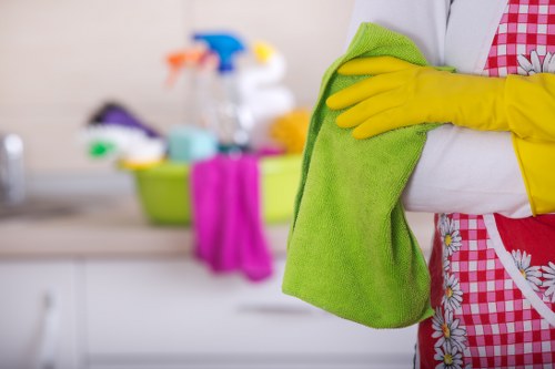 Local office cleaner sanitising desks and touchpoints in a Wimbledon business
