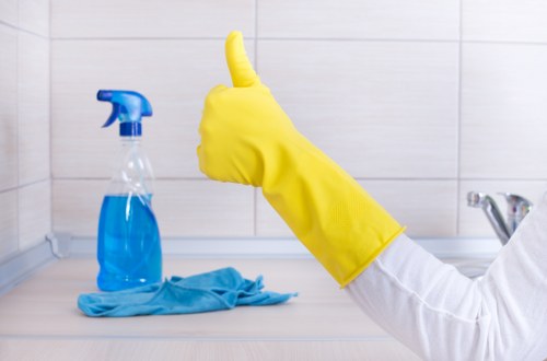 Cleaner maintaining a kitchen during regular cleaning in Wimbledon